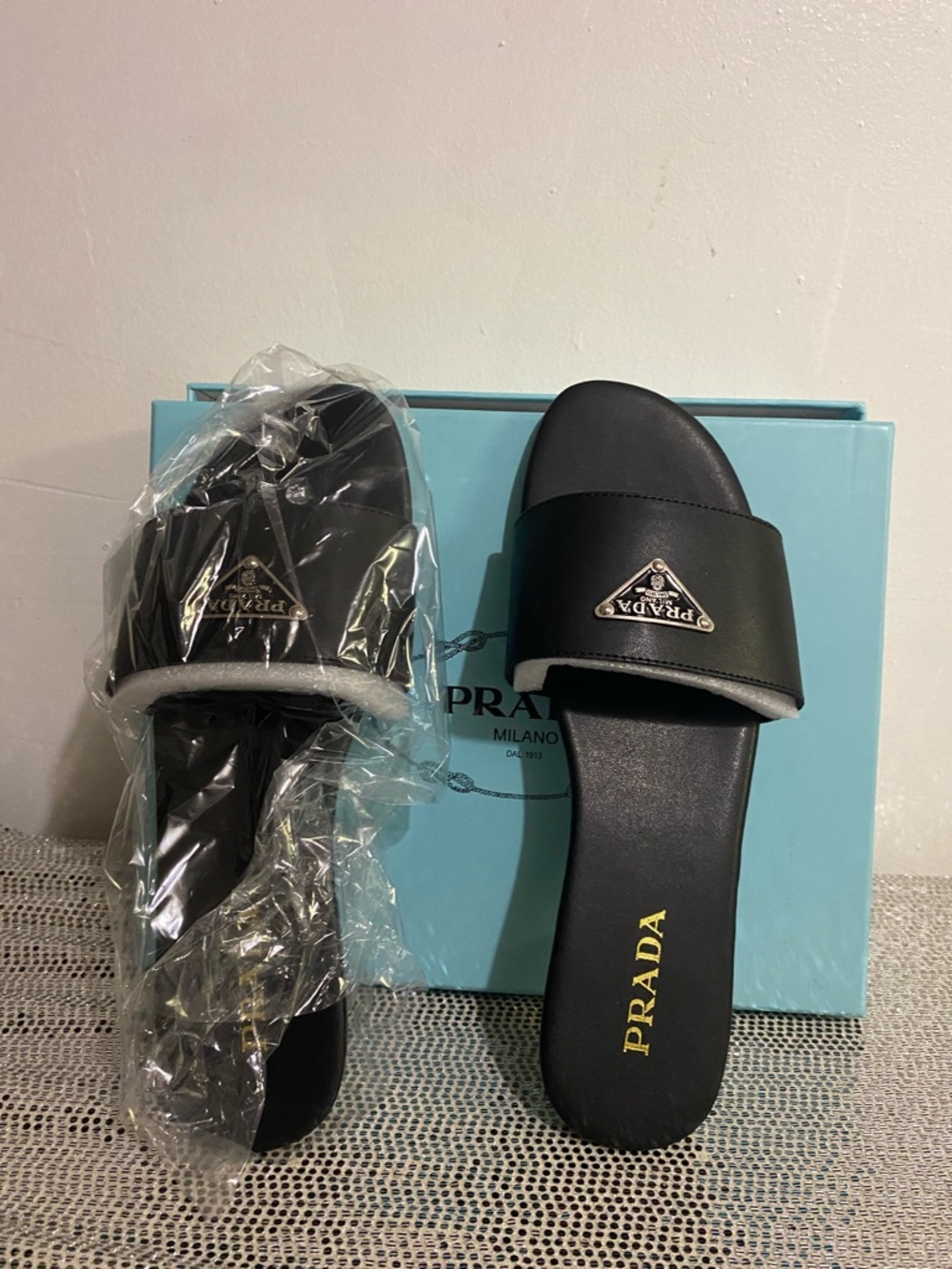 Prada Black Leather Logo Slide Sandals with Gold Emblem